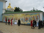 28277 Newly weds at mural by St. Michael's golden domed cathedral.jpg